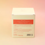 The back of the Blonde Hinoki - HI-FI Soy Wax Candle box on a pink and yellow background.