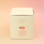The side of the Smoked Cherry - HI-FI Soy Wax Candle box on a pink and yellow background.