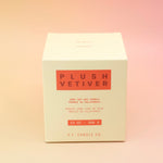 The Plush Vetiver - HI-FI Soy Wax Candle box on a pink and yellow background.