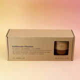 The P.F. Candle Co. - California Classics Gift Set on a pink and yellow background.