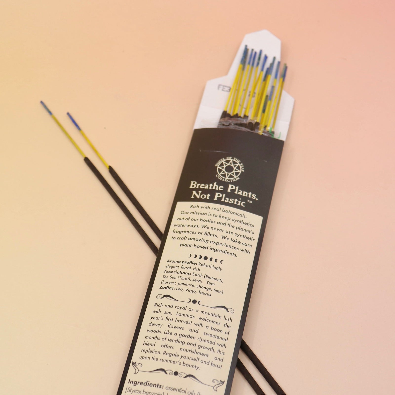 An up close of the Lammas Premium Floral Charcoal Incense on a pink and yellow background.
