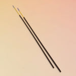 The Lammas Premium Floral Charcoal Incense sticks on a pink and yellow background.