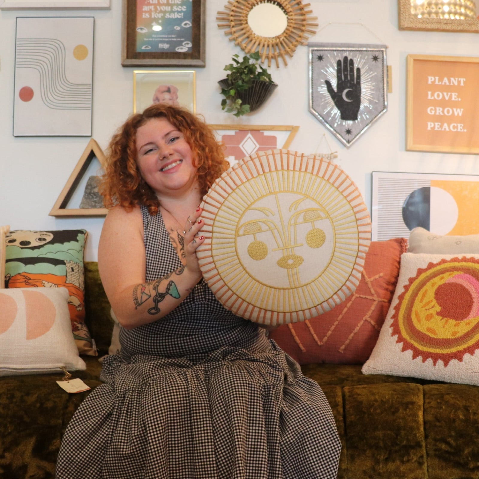A woman holding the Ayo Sunshine Embroidered Decorative Pillow.