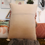 A woman holding the Snack Wool Hook Pillow.