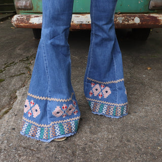 An up-close image of the embroidery on the Midtone Embroidered Denim Bell Bottoms.