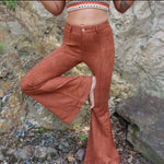 Someone wearing the Pecan Suede Bell Bottoms with an orange, red, and brown top.