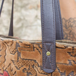 An up close image of the Geometric Velvet Tapestry Tote with Pink Faux Fur.