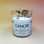 The Cancer Zodiac Crystal Candle on a peach colored background.
