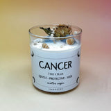 The Cancer Zodiac Crystal Candle on a peach colored background.