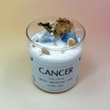 The Cancer Zodiac Crystal Candle on a peach colored background.