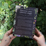 Someone holding the Witchcraft Boxed Set by Arin Murphy-Hiscock in front of greenery showing the back.