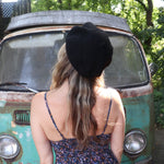 A woman wearing the red Hand-Embroidered Floral Soft Beret Stylish Hat with a black tank, showing off the back.