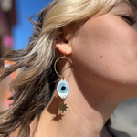 A woman wearing the Brass Future Vision 3 inch. Earrings.