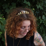 A woman wearing the Fairy Crown / Celtic Tiara - Peruvian Yellow Opal in front of greenery.