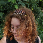 A woman wearing the Fairy Crown / Celtic Tiara - Sea Urchin Spines II in front of greenery.