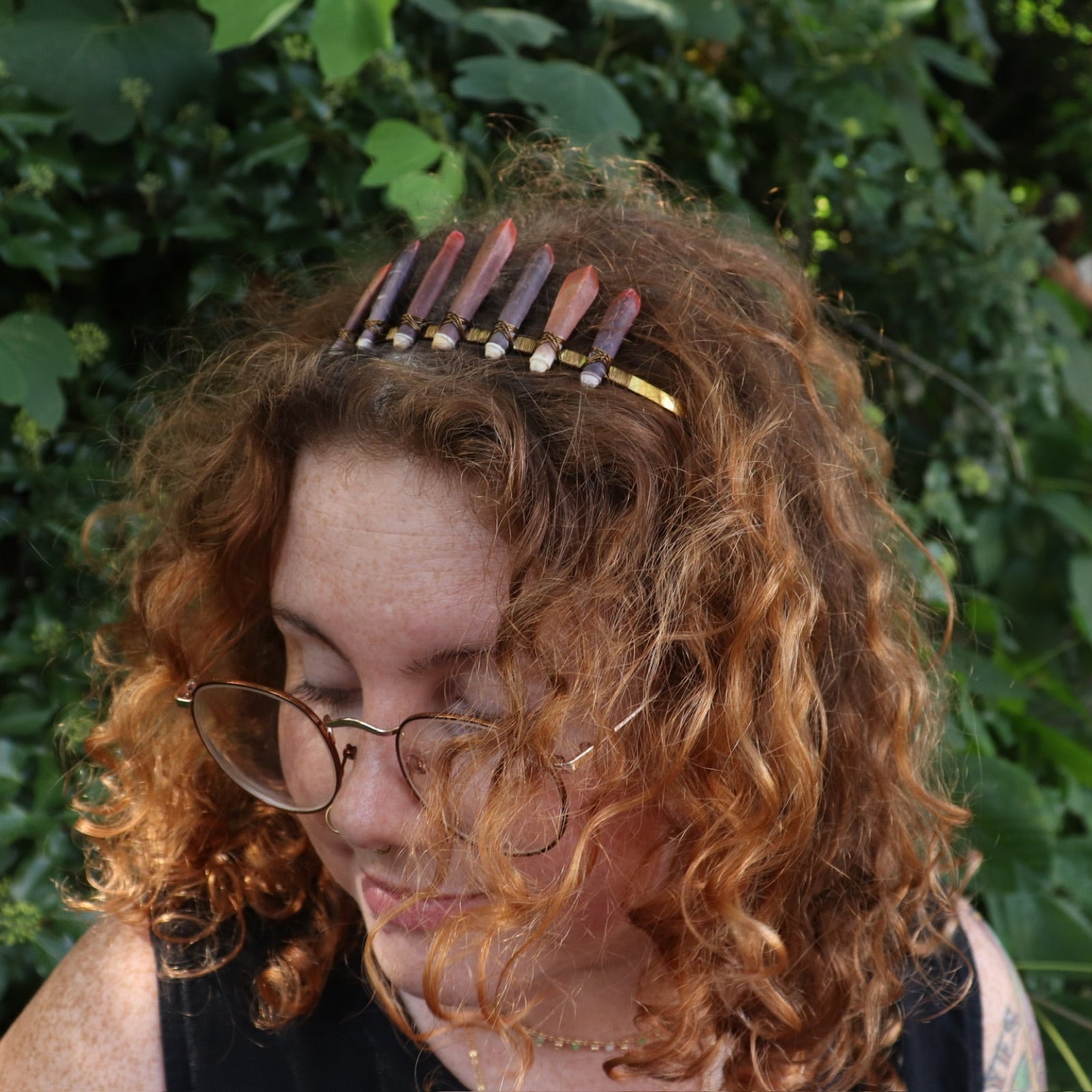 A woman wearing the Fairy Crown / Celtic Tiara - Sea Urchin Spines II in front of greenery.