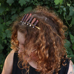 A woman wearing the Fairy Crown / Celtic Tiara - Sea Urchin Spines II in front of greenery.