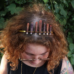 A woman wearing the Fairy Crown / Celtic Tiara - Sea Urchin Spines II in front of greenery.