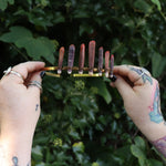 Someone holding the Fairy Crown / Celtic Tiara - Sea Urchin Spines II in front of greenery.