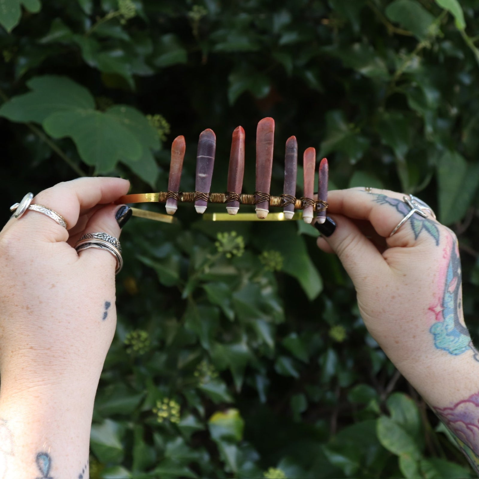 Someone holding the Fairy Crown / Celtic Tiara - Sea Urchin Spines II in front of greenery.