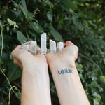 Someone holding the Fairy Crown / Celtic Tiara - Moonstone - Ice Queen in front of greenery.