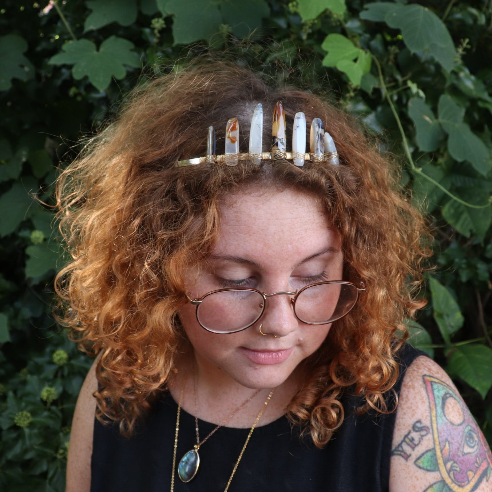 A woman wearing the Fairy Crown / Celtic Tiara - Agate Spears in front of greenery.
