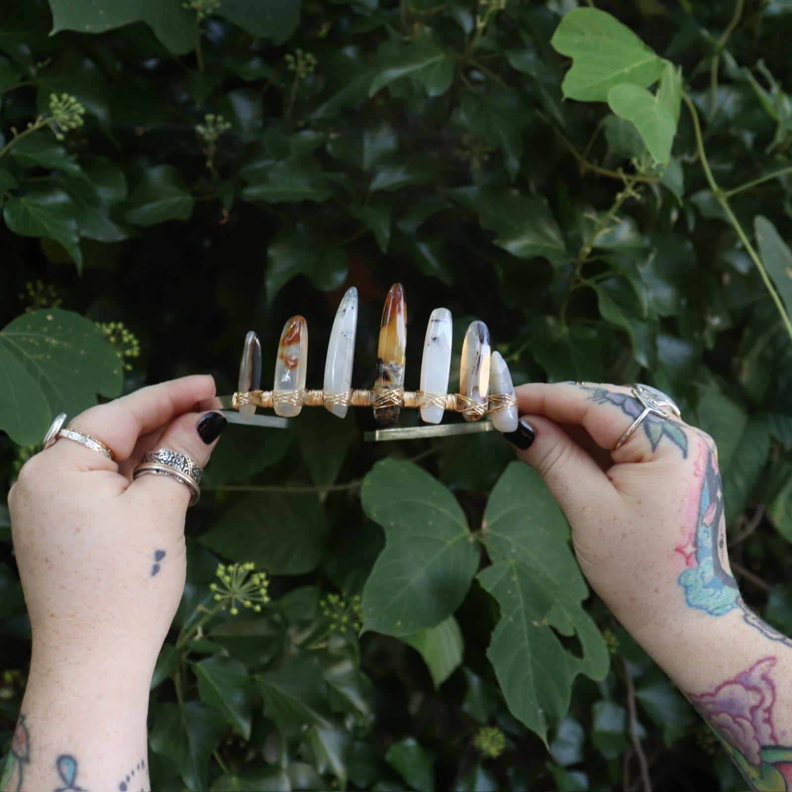 Someone holding the Fairy Crown / Celtic Tiara - Agate Spears in front of greenery.