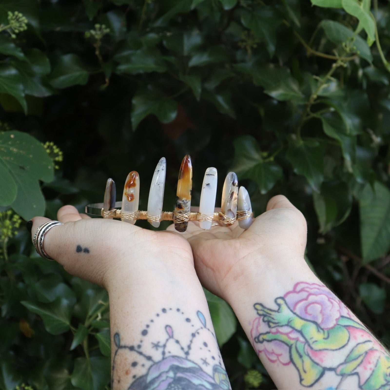 Someone holding the Fairy Crown / Celtic Tiara - Agate Spears in front of greenery.