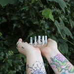 Someone holding the Fairy Crown / Celtic Tiara - Oregon Blue Opal in front of greenery.