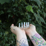 Someone holding the Fairy Crown / Celtic Tiara - Oregon Blue Opal in front of greenery.