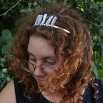 A woman wearing the Fairy Crown / Celtic Tiara - Blue Chalcedony in front of greenery.