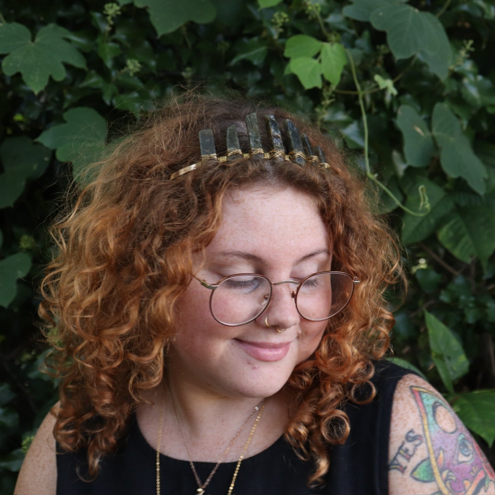 A woman wearing the Fairy Crown / Celtic Tiara - Labradorite in front of greenery.