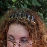 A woman wearing the Fairy Crown / Celtic Tiara - Labradorite in front of greenery.