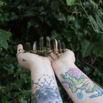 Someone holding the Fairy Crown / Celtic Tiara - Labradorite in front of greenery.