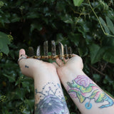 Someone holding the Fairy Crown / Celtic Tiara - Labradorite in front of greenery.