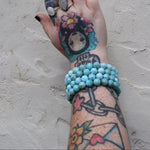 Someone wearing three of the large Natural Larimar Bracelet – 7.5” Stretch Fit.