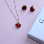 The gold Carnelian Earrings & Necklace Gift Jewelry Set on a pink background.