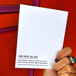 Someone holding the Outer Space I Love You Letterpress Greeting Card in front of an orange and pink wall.