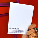 Someone holding the Outer Space I Love You Letterpress Greeting Card in front of an orange and pink wall.