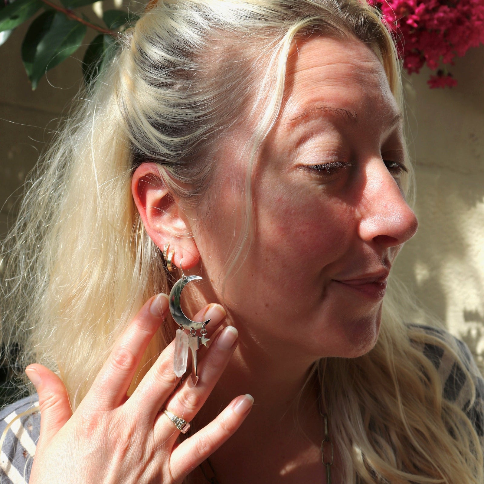 A woman wearing the Silver Sisters of the Moon 3 inch. Earrings.