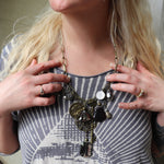 A woman wearing the Gypsy Junk Original-Gray 24" Necklace with a gray shirt.