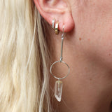Someone wearing the silver Quartz Crystal Drop Earrings.