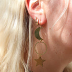 Someone wearing the Brass Rhiannon Moon and Star 3 inch. Earrings.
