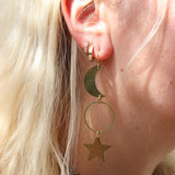 Someone wearing the Brass Rhiannon Moon and Star 3 inch. Earrings.