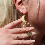 Someone wearing the Brass Rhiannon Moon and Star 3 inch. Earrings.