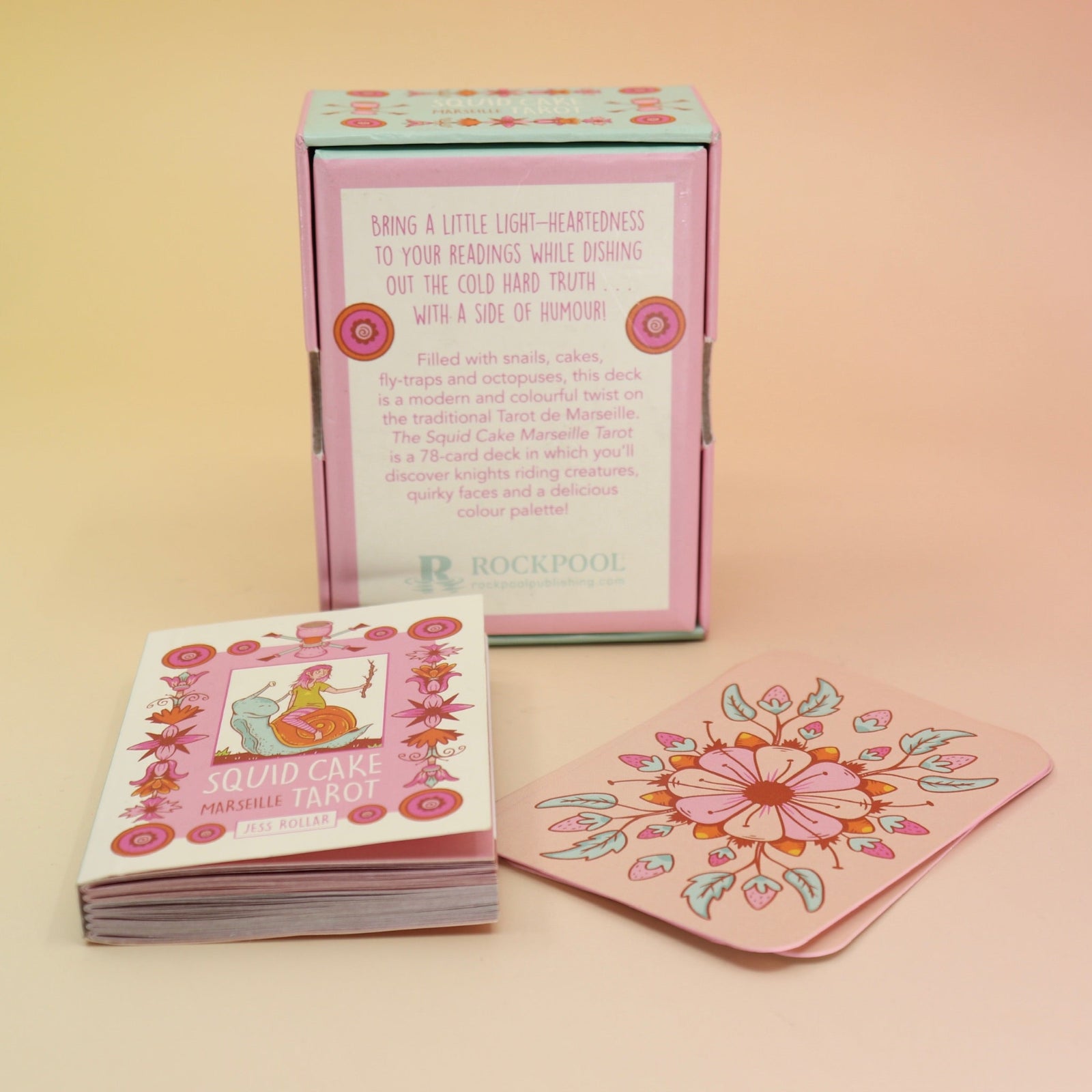 The contents of the Squid Cake Marseille Tarot Deck all on a pink and yellow background.