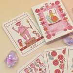 The contents of the Squid Cake Marseille Tarot Deck all on a pink and yellow background.