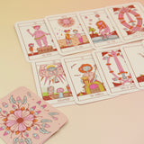 The contents of the Squid Cake Marseille Tarot Deck all on a pink and yellow background.