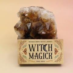 The Witch Magick Affirmation + Divination Cards against a citrine piece all on a pink and yellow background.