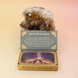 The Magical Messages from the Universe Affirmation + Divination Cards leaning against a citrine piece all on a pink and yellow background.